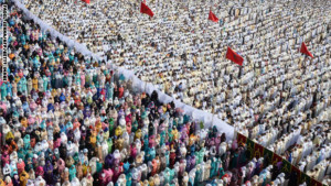 Moroccan Muslim women (L) and men (R) perform prayers for Eid al-Fitr which marks the end of the Muslim holy fasting month of Ramadan in the city of Sale, north of the Moroccan capital Rabat, on July 18, 2015. AFP PHOTO/ FADEL SENNA        (Photo credit should read FADEL SENNA/AFP/Getty Images)
